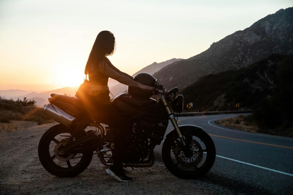 Woman Riding Motorcycle on Roadside